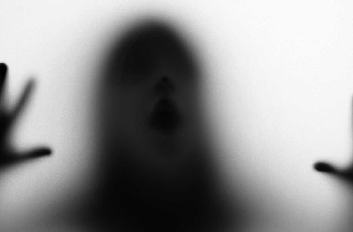 a girl  silhouette behind a  transparent  paper