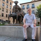 Javier Blázquez sentado en la escultura del Conde de Francos y Churriguera.